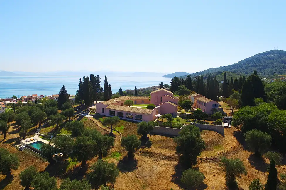Aerial view of The Courti Estate, with sea views on a sunny day.