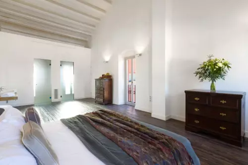 Bedroom with white walls and chest of drawers