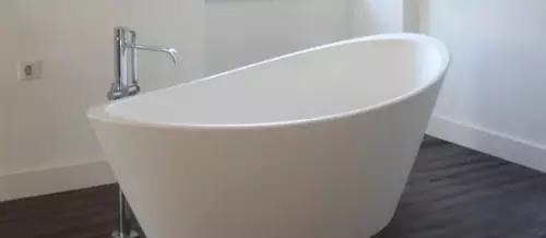 White free standing bath with chrome tap